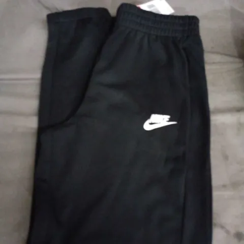 NIKE KIDS BLACK TRACKSUIT TROUSERS WITH WHITE SWOOSH LOGO - AGE UNSPECIFIED