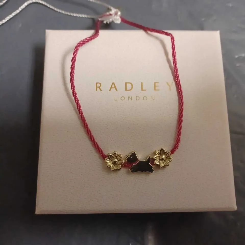 RADLEY LADIES 18CT GOLD PLATED FLOWER AND JUMPING DOG DARK ROSE CORD FRIENDSHIP BRACELET