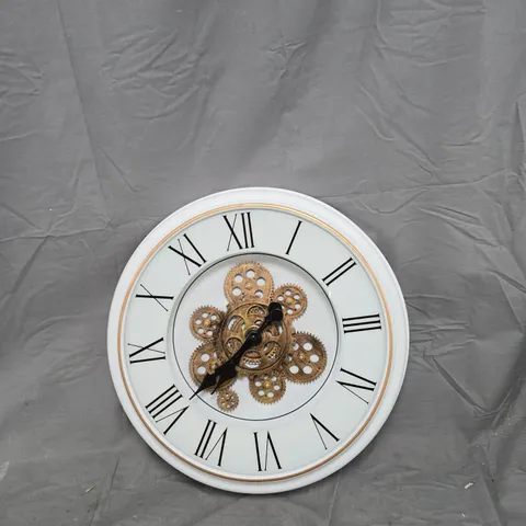 WHITE WALL CLOCK WITH ROMAN NUMERALS AND EXPOSED GEARS