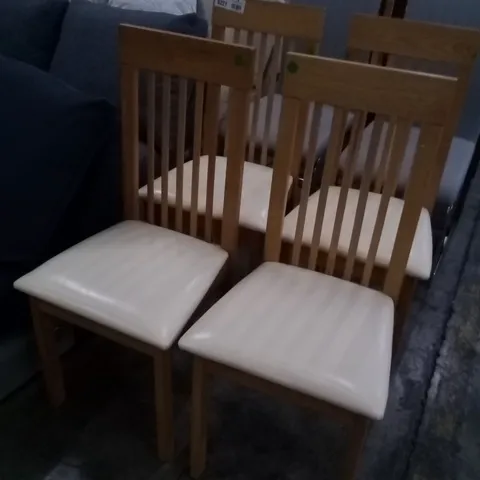 APPROXIMATELY 4 OAK EFFECT SLATTED BACK DINING CHAIRS WITH CREAM FAUX LEATHER SEAT PADS