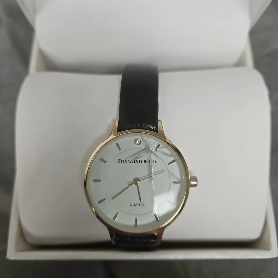 DIAMOND & CO. GOLD-TONE WRISTWATCH WITH WHITE DIAL, BLACK LEATHER STRAP