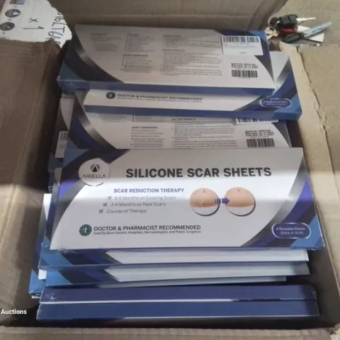 BOX CONTAINING LARGE AMOUNT OF SILICONE SCAR SHEETS.