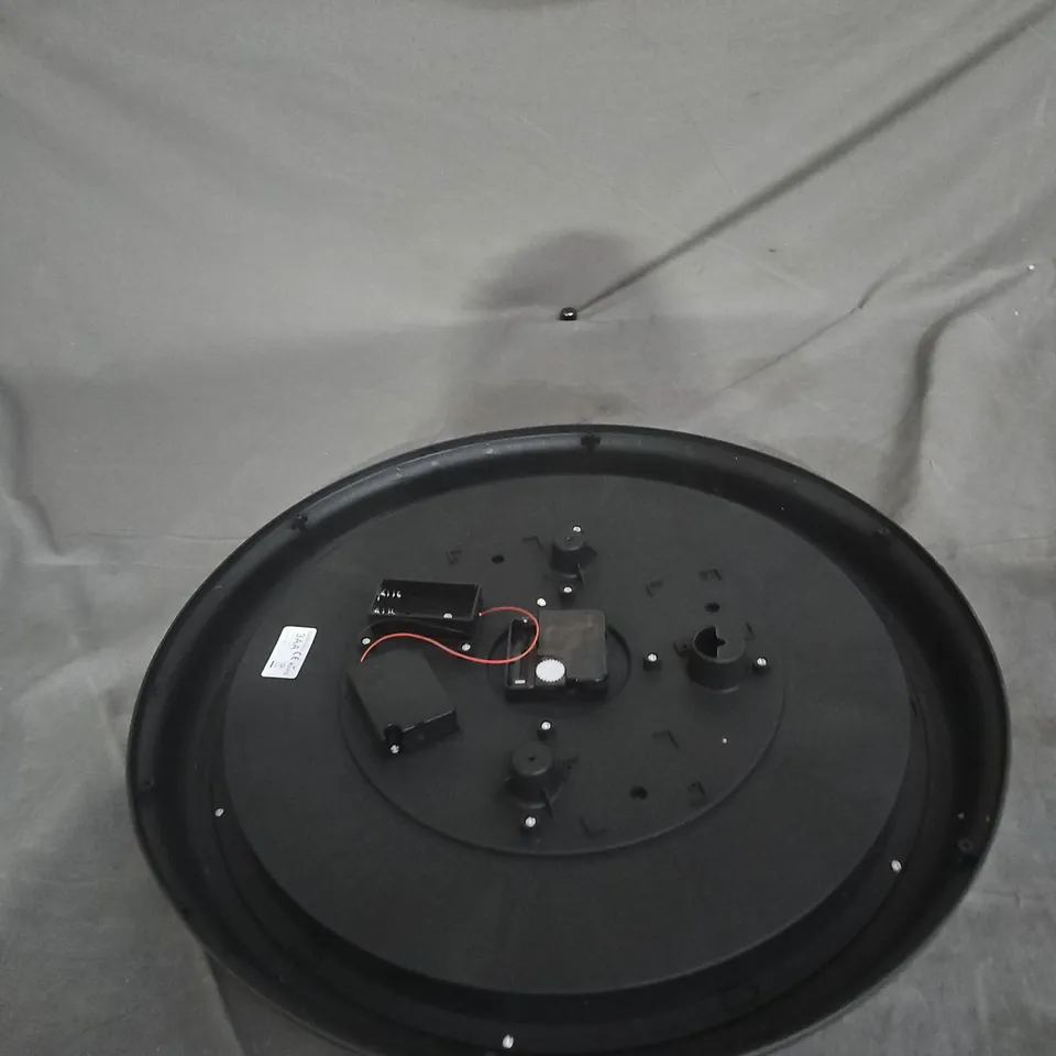 ROUND WALL CLOCK WITH EXPOSED BRASS GEARS, ROMAN NUMERALS, BLACK FINISH