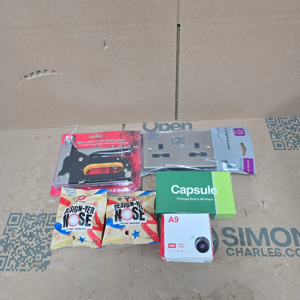 TOTE OF APPROXIMATELY 20 ASSORTED HOUSEHOLD ITEMS TO INCLUDE RED NOSE DAY "DESIGN YOUR NOSE", STAPLE GUN, CAPSULE FILTER, HD BATTERY IP CAMERA, SWITCHED SOCKET ETC