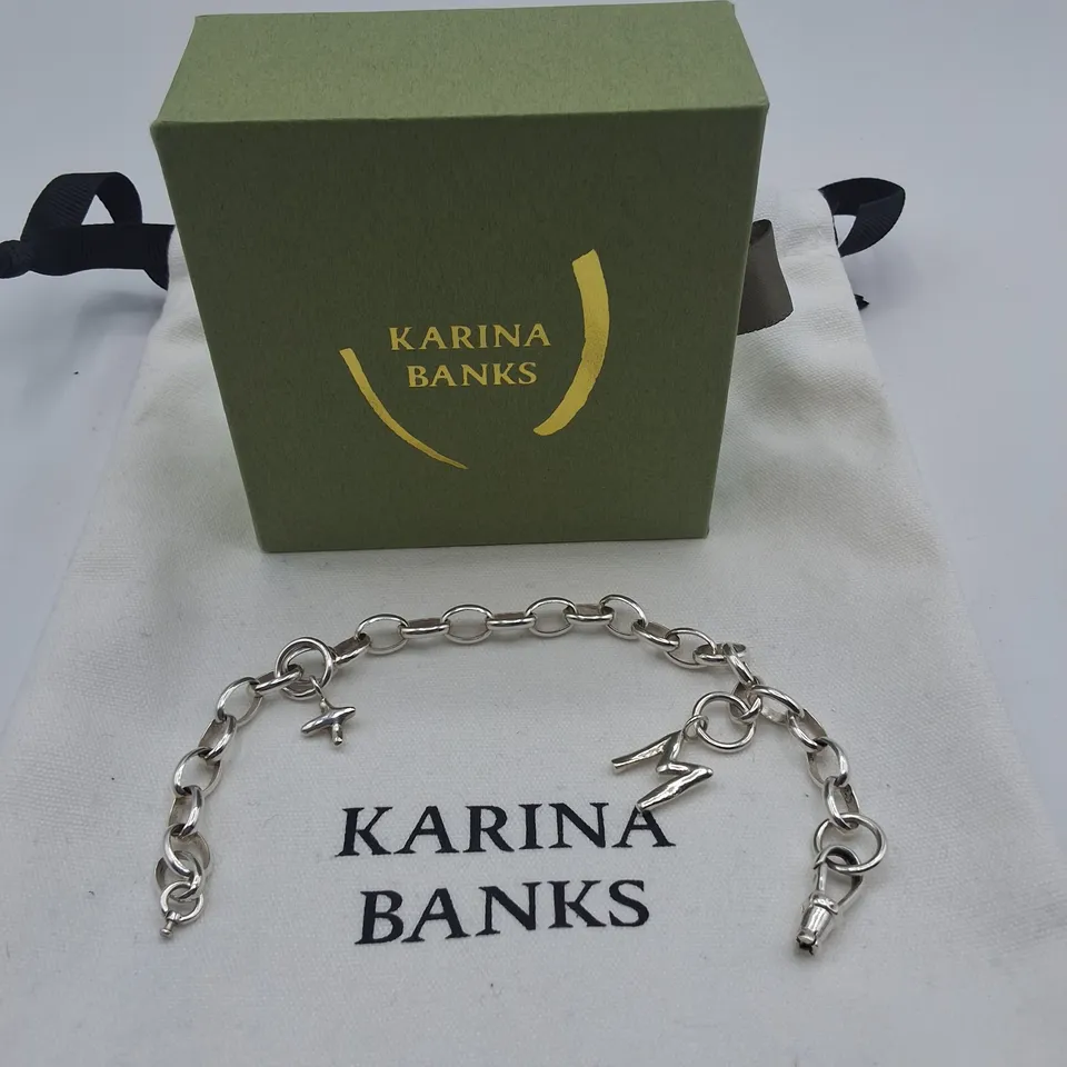 BOXED KARINA BANKS SILVER TONE BRACELET WITH CHARMS