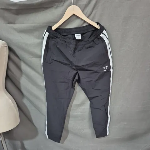 GYMSHARK MEN'S TRACK PANTS – BLACK WITH WHITE SIDE STRIPES, SIZE M