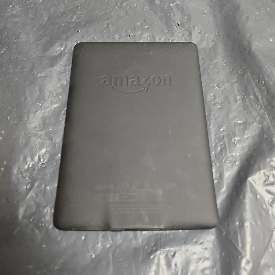 AMAZON KINDLE E-READER – BLACK, WITH LOW BATTERY MESSAGE