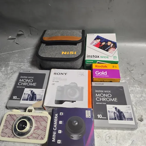 TOTE OF ASSORTED CAMERA ACESSORIES TO INCLUDE GRIP EXTENSION, MINI CAMERA AND INSTAX WIDE
