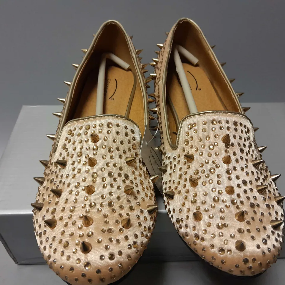 APPROXIMATELY 13 CASANDRA SPIKED SLIPONS IN CHAMPAGNE SATIN IN VARIOUS SIZES