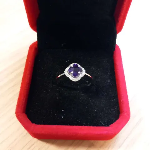 18CT WHITE GOLD HALO RING SET WITH A FOUR LEAF CLOVER SHAPED AMETHYST AND NATURAL DIAMONDS