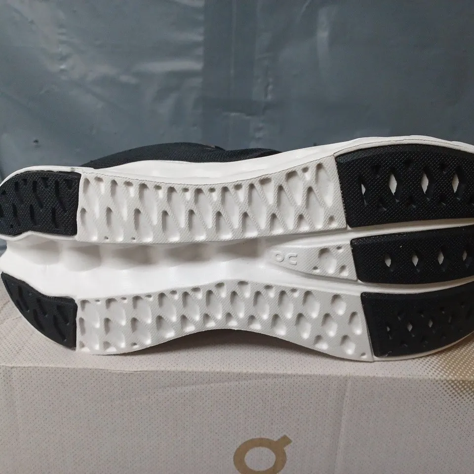BOXED PAIR OF ON CLOUDSURFER TRAINERS IN BLACK/WHITE - UK 6