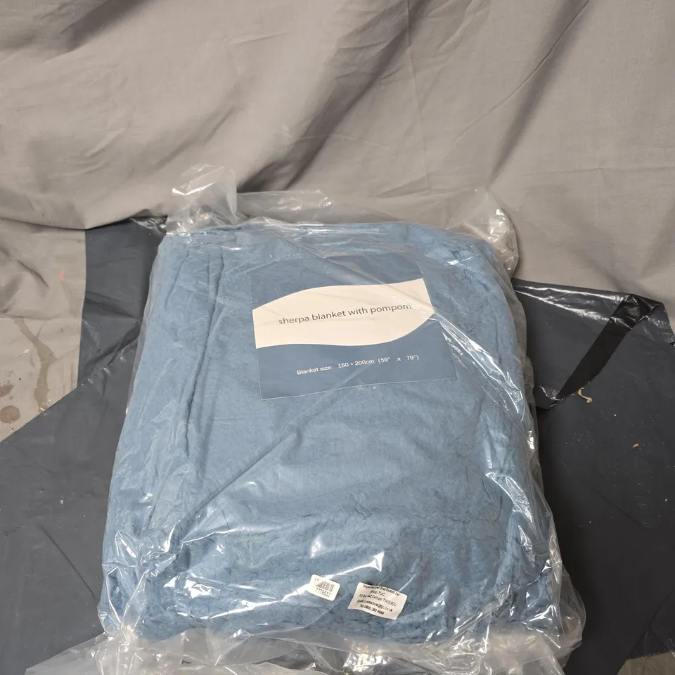 SHERPA BLANKET WITH POM POM, SEALED