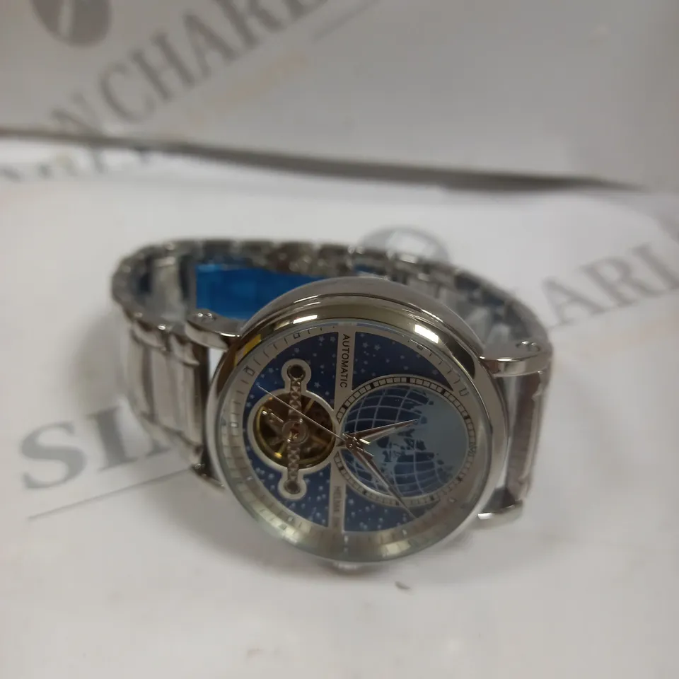 MEN’S HELMA DH AUTOMATIC WORLD VIEW WATCH – TOURBILLON MOVEMENT – BLUE DIAL – STAINLESS STEEL STRAP – GLASS EXHIBITION BACK CASE – LEATHER STRAP INCLUDED 