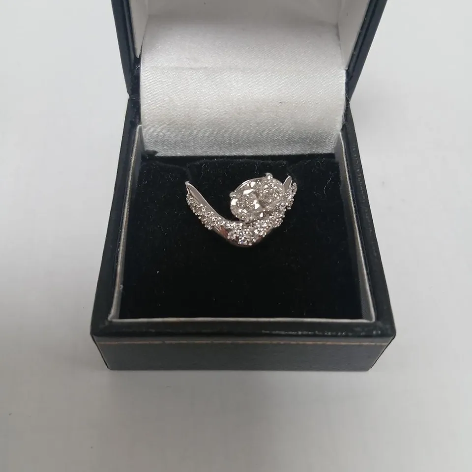9CT WHITE GOLD TWIST RING SET WITH A LAB GROWN OVAL CUT DIAMOND AND PAVE BAND WEIGHING +1.77CT