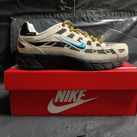 BOXED PAIR OF NIKE P-6000 PRM TRAINERS IN CREAM/BLUE/BLACK SIZE UK 6