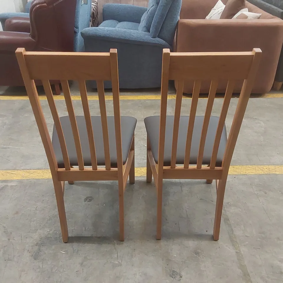 PAIR OF DESIGNER WOODEN DINING CHAIRS WITH PADDED UPHOLSTERED SEATS