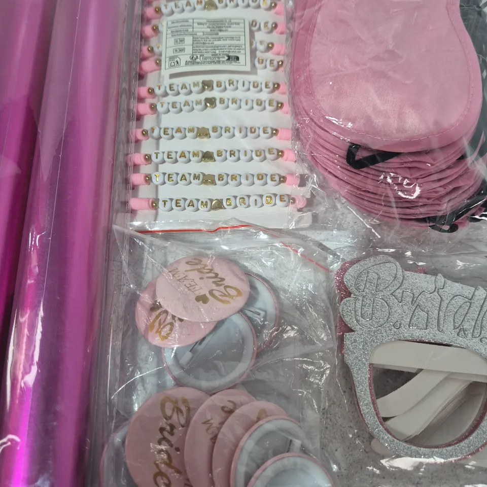LOT OF ASSORTED BRIDESMAID THEMED PARTY ITEMS IN PINK TO INCLUDE GIFT WRAP. GLASSES, BADGES AND BRACELETS