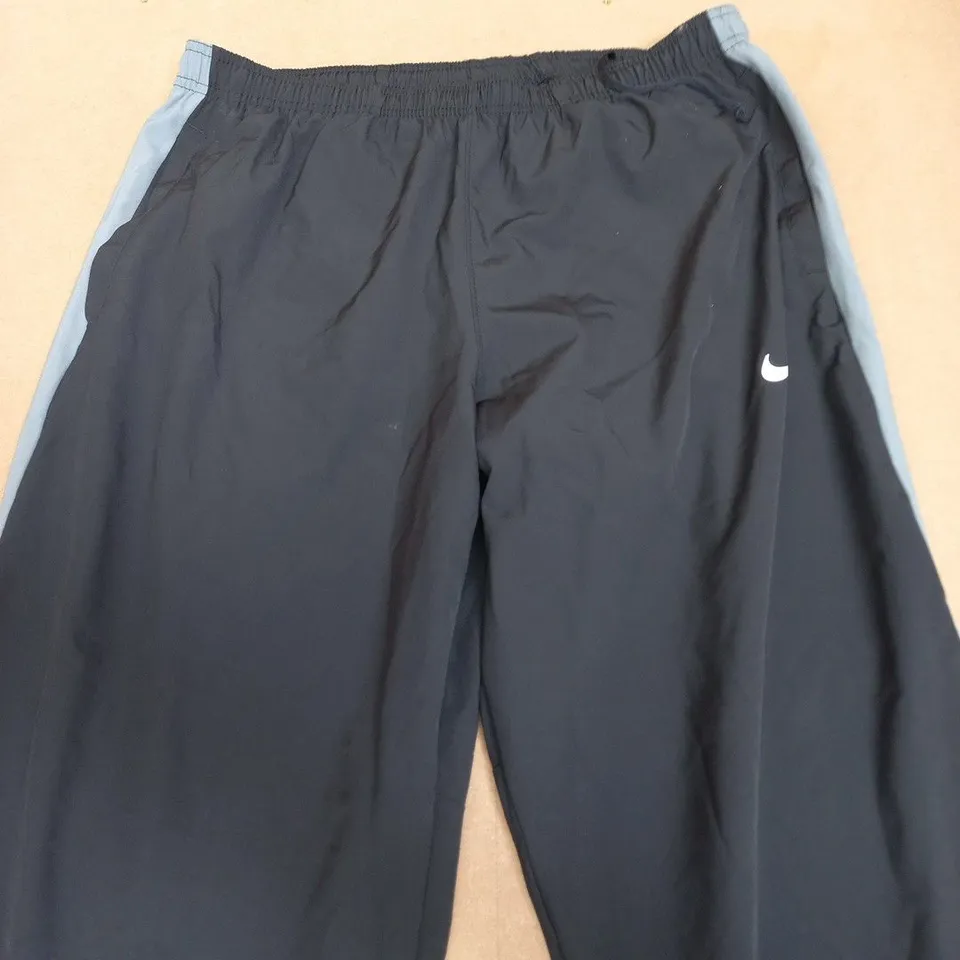NIKE DRI-FIT TRACK PANTS – NAVY WITH LIGHT BLUE SIDE STRIPES SIZE L