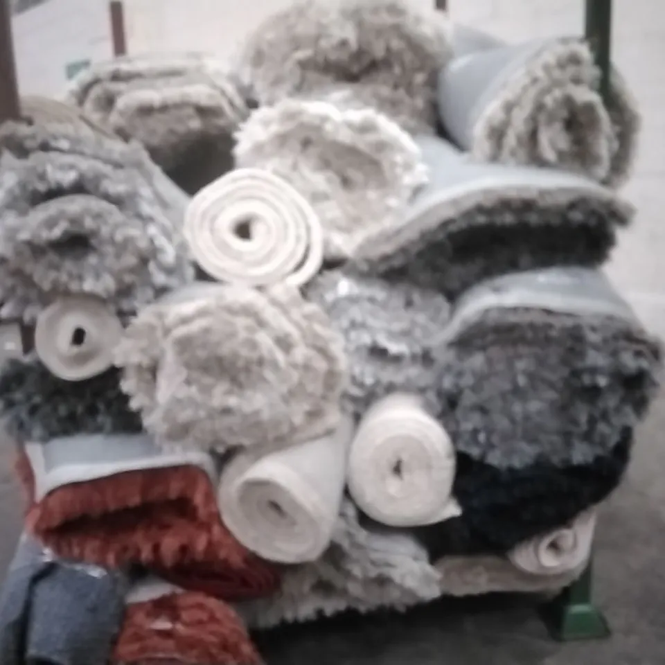 STILLAGE OF APPROXIMATELY 20 DESIGNER RUGS