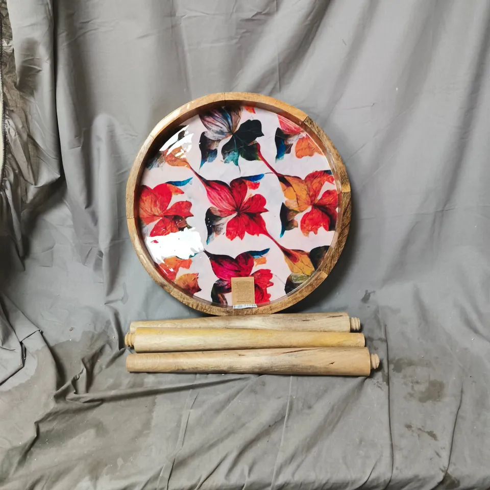 ROUND DECORATIVE TABLE WITH FLORAL PRINT AND WOODEN RIM, WITH LEGS. ITEM HAS CRACK IN DESIGN