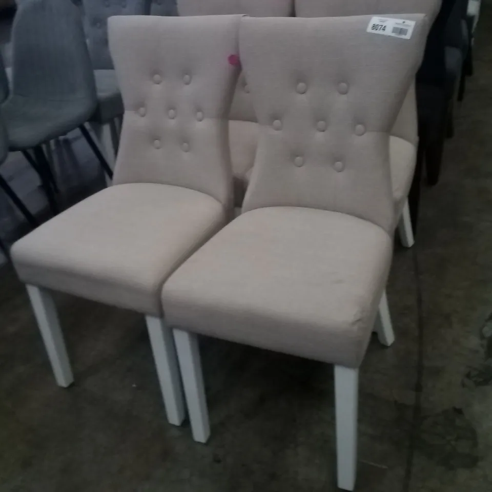 APPROXIMATELY 4 BEIGE FABRIC BUTTON BACK DINING CHAIRS WITH WHITE LEGS