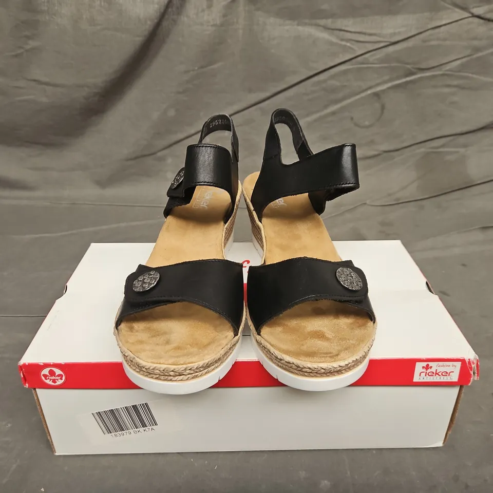 BOXED PAIR OF WOMENS RIEKER BLACK STRAP WEDGE SANDALS - UK SIZE 41