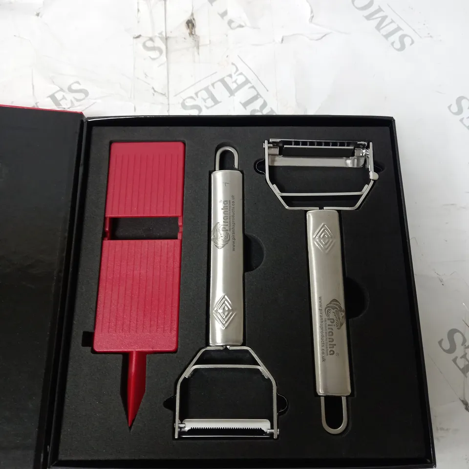 BOX OF APPROX. 5 ASSORTED PIRANHA PRODUCTS TO INCLUDE PEELERS WITH THE SHARP TEETH, SPIRAL CUTTER, PRO CUT SCISSORS, ETC. 