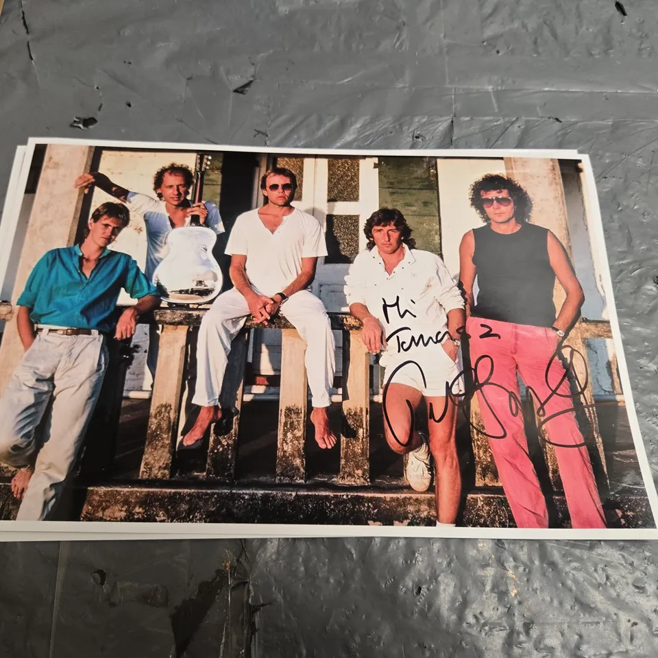 SET OF 4 AUTOGRAPHED ROCK PHOTOGRAPHS (SIGNED BY MARK KNOPFLER)