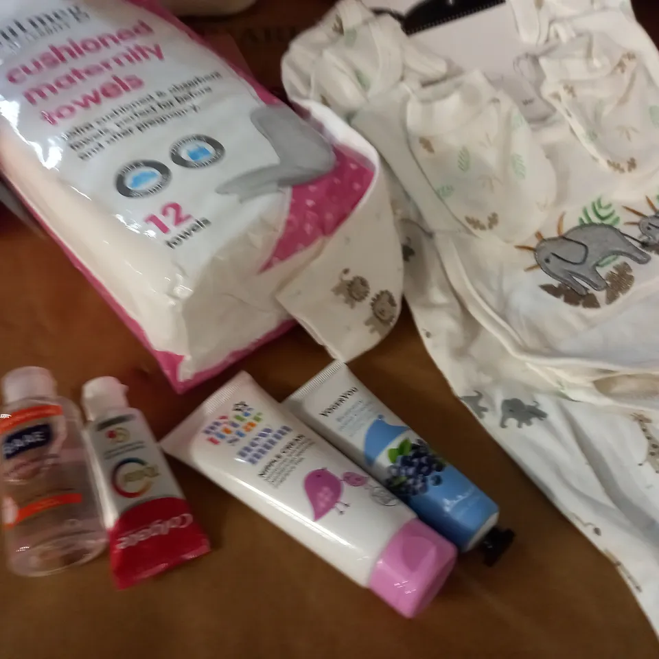 PINK MULTI-COMPARTMENT BAG WITH VARIOUS BABY CARE ITEMS