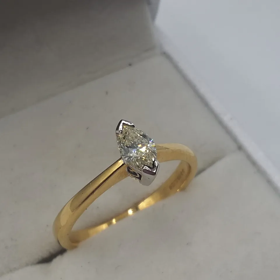 18CT GOLD SOLITAIRE RING SET WITH A NATURAL MARQUISE CUT DIAMOND