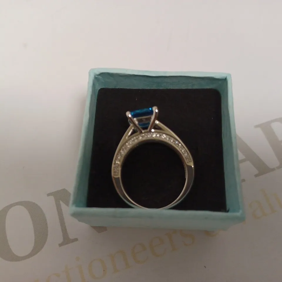SILVER LOOP RING WITH PRINCESS CUT BLUE STONE