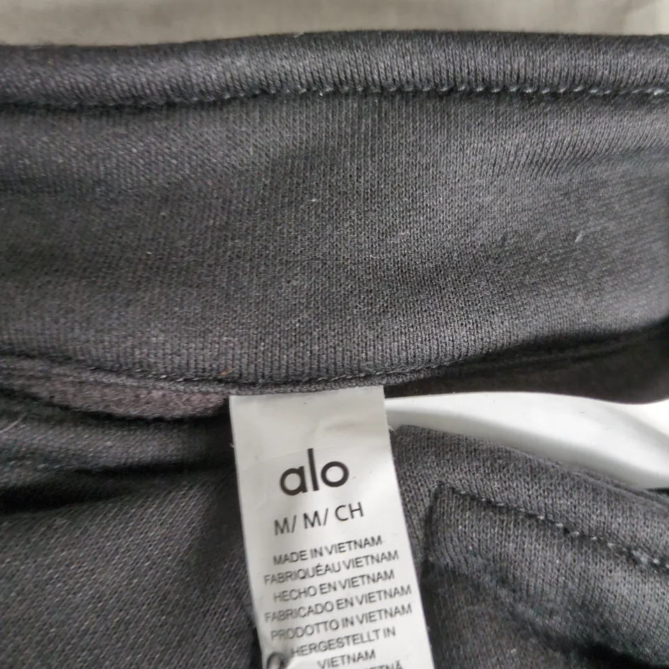 ALO YOGA ZIP FRONT JUMPER – BLACK, UK M