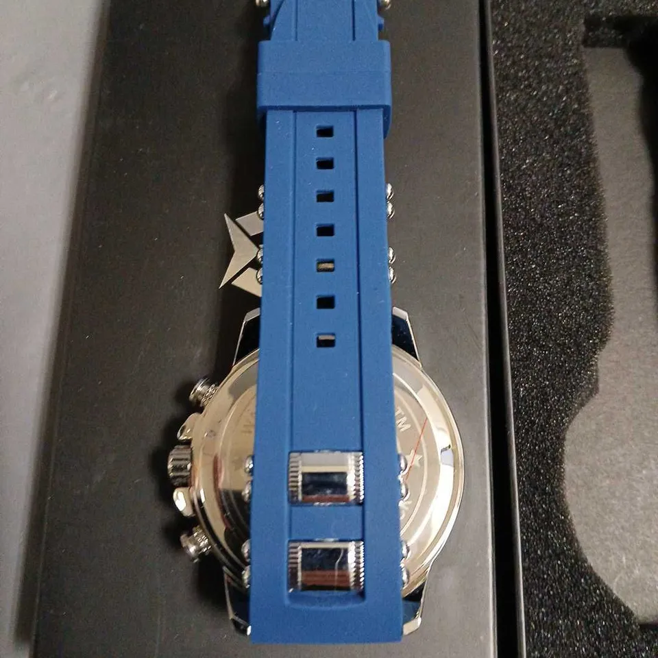 BOXED MEGALITH SKELETON FACED GENTS WATCH WITH STAINLESS STEEL BACK AND BLUE RUBBER STRAP