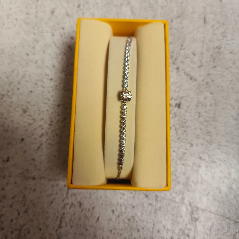 BOXED SWAROVSKI BRACELET WITH PAVÉ-SET CLEAR STONES AND A CENTRAL ROUND GEMSTONE