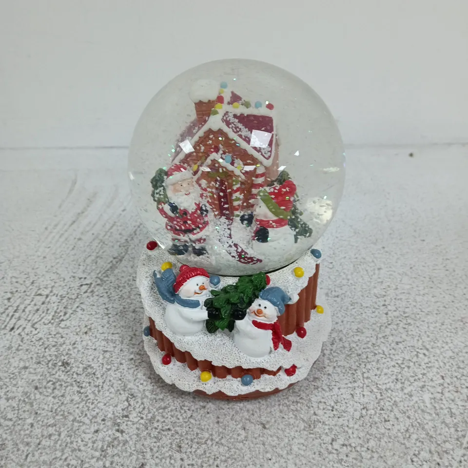 DECORATIVE CHRISTMAS SNOW GLOBE WITH SANTA, SNOWMEN AND COTTAGE SCENE