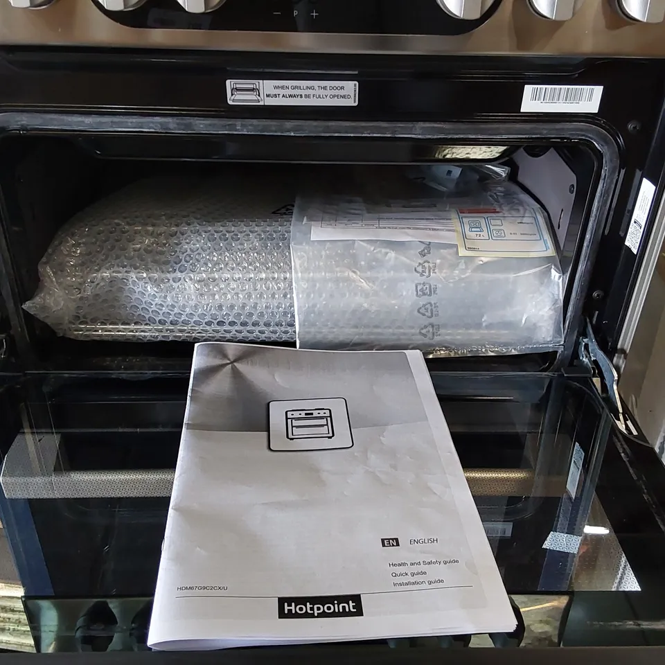 HOTPOINT DOUBLE OVEN AND GAS HOBS IN BLACK AND SILVER HANDLES 