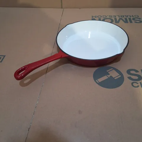 RED ENAMELED CAST IRON FRYING PAN WITH A WHITE COOKING SURFACE