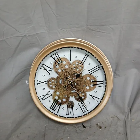 ROUND BRASS-TONE WALL CLOCK WITH EXPOSED GEARS AND ROMAN NUMERALS