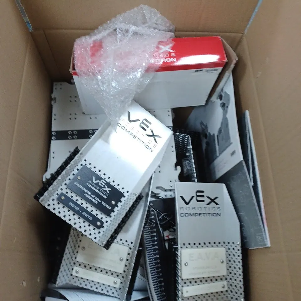 BOX OF ASSORTED VEX ITEMS TOO INCLUDE TEXTBOOKS , PLASTIC BACKGROUND SAND VEX TROPHY'S 