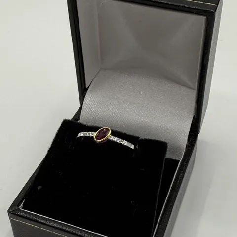 18CT GOLD RING SET WITH AN OVAL CUT RUBY AND NATURAL DIAMONDS