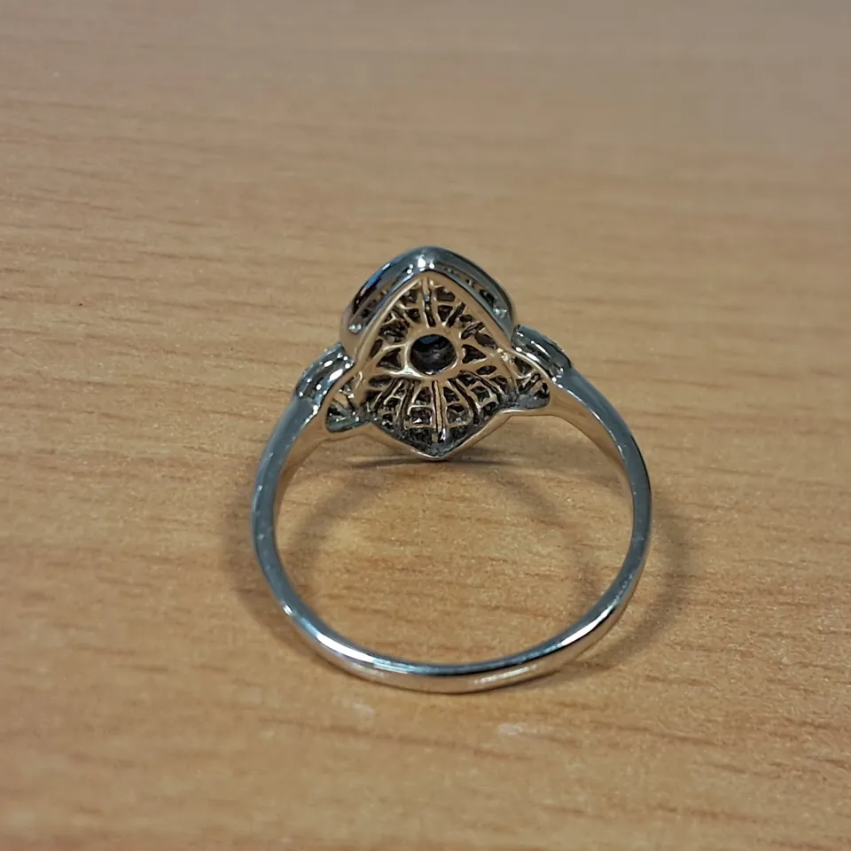 18CT WHITE GOLD DRESS RING SET WITH AN OVAL CUT SAPPHIRE AND NATURAL DIAMONDS