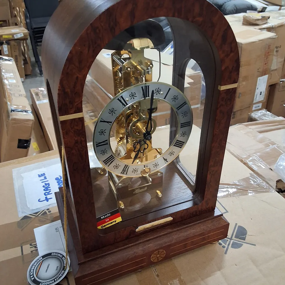 HERMLE MECHANICAL TABLE CLOCK WITH ARCHED WALNUT CASING AND HOUR STRIKE 30CM X 19CM X 13.5CM