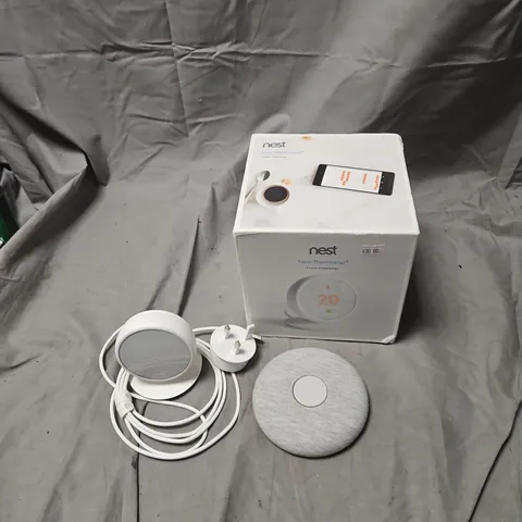 NEST THERMOSTAT E – BOXED WITH POWER ADAPTER AND FABRIC-COVERED THERMOSTAT .