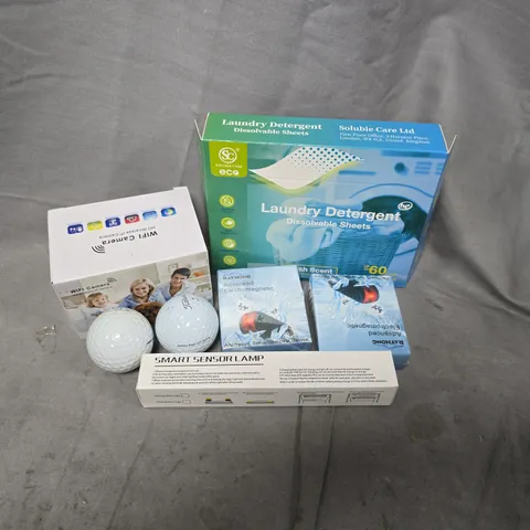 APPROXIMATELY 12 ASSORTED HOUSEHOLD ITEMS TO INCLUDE TITLEIST GOLF BALLS, WIFI CAMERA, LAUNDRY SHEETS, ETC