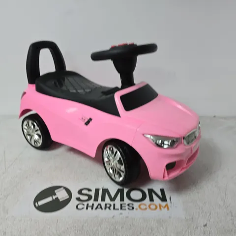 PINK CHILDREN'S RIDE-ON TOY CAR WITH BLACK SEAT AND CHROME WHEELS