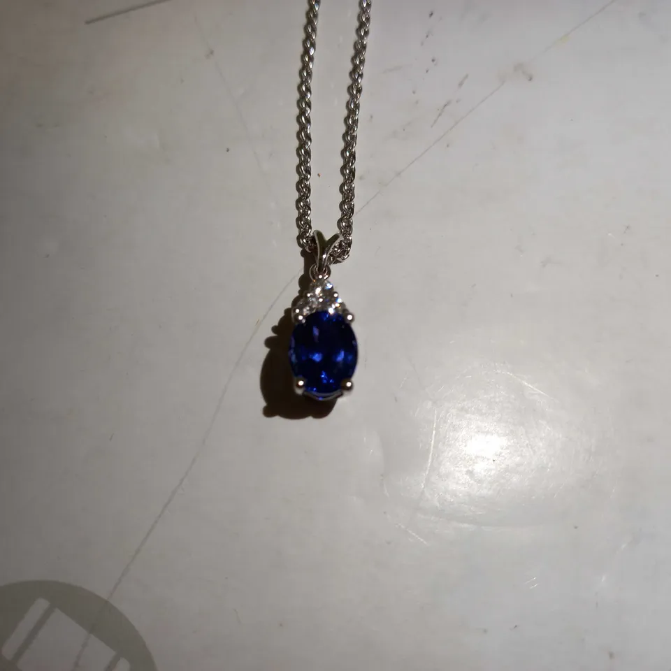 DESIGNER 18CT WHITE GOLD PENDANT ON A CHAIN, SET WITH AN OVAL CUT TANZANITE AND DIAMONDS WEIGHING +-2.67CT