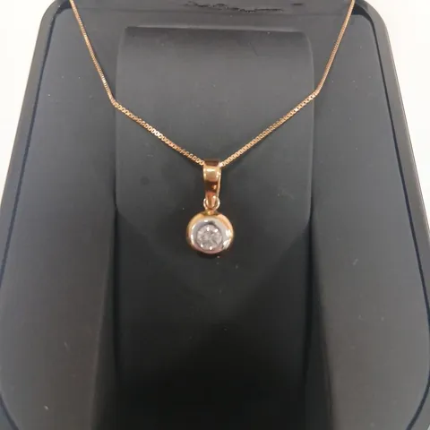 18CT GOLD RUBOVER PENDANT ON A CHAIN SET WITH A NATURAL DIAMOND
