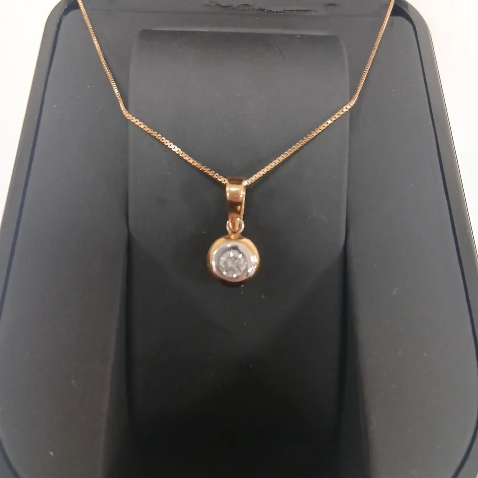 18CT GOLD RUBOVER PENDANT ON A CHAIN SET WITH A NATURAL DIAMOND