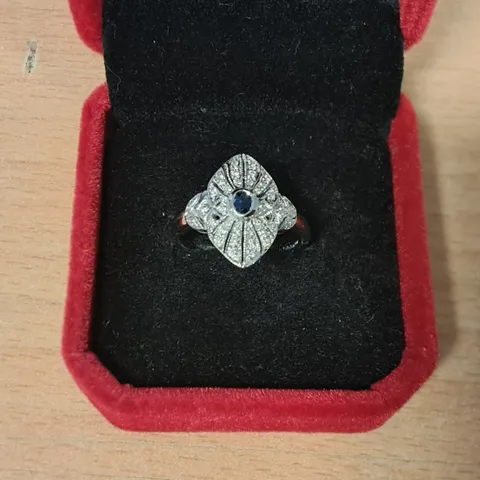 18CT WHITE GOLD DRESS RING SET WITH AN OVAL CUT SAPPHIRE AND NATURAL DIAMONDS