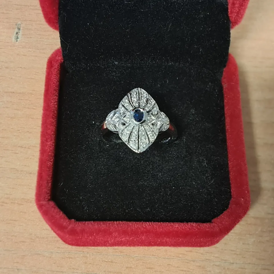 18CT WHITE GOLD DRESS RING SET WITH AN OVAL CUT SAPPHIRE AND NATURAL DIAMONDS